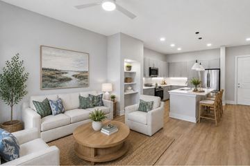 Charleston apartment for rent - A living room with a white couch, a coffee table, and a painting on the wall.