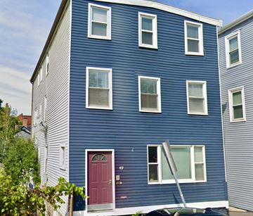 Brookline apartment for rent - A blue house with a red door and a ladder leaning against it.