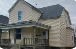 Columbus apartment for rent - A house with a porch and a small front yard.
