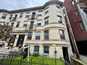 Boston apartment for rent - A building with a black iron fence in front of it.