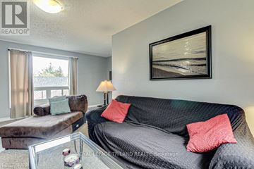 London North (North N) apartment for rent - A living room with a grey couch, a coffee table, and a painting on the wall.