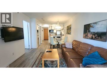 Vancouver apartment for rent - A living room with a brown leather couch and a wooden coffee table.