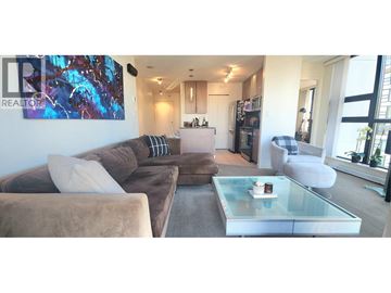 Vancouver apartment for rent - A living room with a brown couch and a glass coffee table.