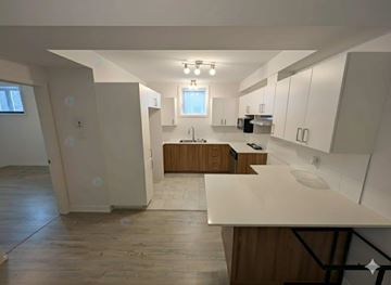 Gatineau (Gatineau) apartment for rent - A kitchen with wooden cabinets and a white countertop.