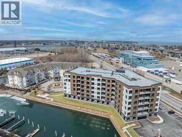 Point Edward apartment for rent - A large building with a boat docked in front of it.
