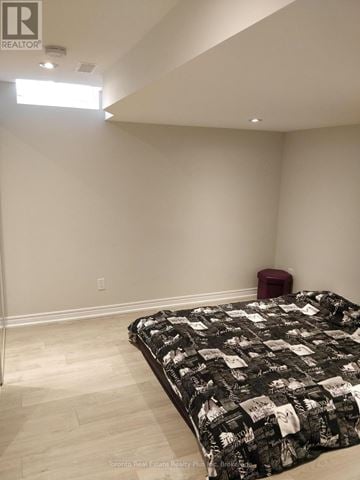 Richmond Hill (Oak Ridges Lake Wilcox) apartment for rent - A bedroom with a bed and a red stool.