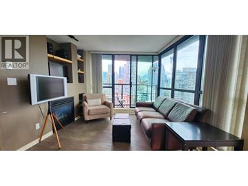 Vancouver apartment for rent - A living room with a brown leather couch and a flat screen TV mounted on the wall.
