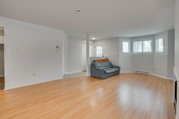 Gatineau (Aylmer) apartment for rent - A living room with a grey couch and wooden floors.