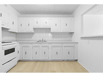 Gatineau (Aylmer) apartment for rent - A kitchen with white cabinets and a white stove.