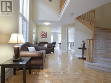 Mississauga (Churchill Meadows) apartment for rent - A living room with a brown couch and a wooden table.