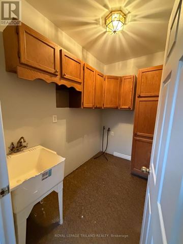 Southwold apartment for rent - A kitchen with wooden cabinets and a white sink.