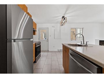 Gatineau (Hull) condo for rent - A kitchen with a stainless steel refrigerator and a sink.