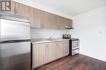 Guelph (Riverside Park) multi-family for rent - A kitchen with wooden cabinets and stainless steel appliances.