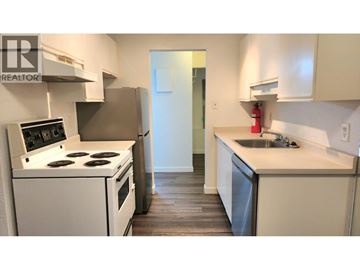 Vancouver apartment for rent - A kitchen with a stove, sink, and cabinets.