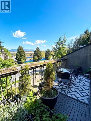 Vancouver apartment for rent - A kitchen with white cabinets and a black fridge.