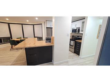 Gatineau (Hull) apartment for rent - A modern kitchen with a wooden counter and black drawers.