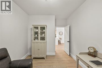 Chatham apartment for rent - A living room with a grey sofa and a wooden cabinet.