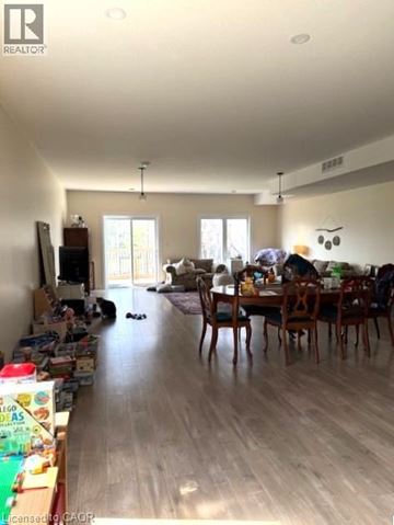 Kitchener apartment for rent - A living room with a dining table and chairs.