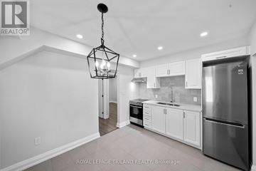 Hamilton (Delta) multi-family for rent - A modern kitchen with white cabinets and stainless steel appliances.