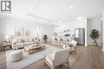 Kitchener townhouse for rent - A modern living room with a kitchen in the background.