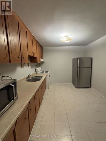 Toronto (Cabbagetown-South St. James Town) apartment for rent - A kitchen with wooden cabinets and a refrigerator.