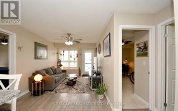Milton (Wi Willmott) condo for rent - A well-lit living room with a grey sofa and a coffee table.
