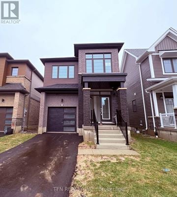 Thorold (Hurricane/Merrittville) apartment for rent - A house with a driveway in front of it.