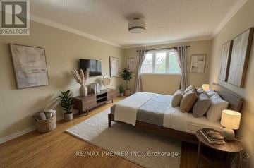 Vaughan (Patterson) apartment for rent - A bedroom with a bed, nightstand, and a window with curtains.