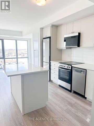 Clarington (Bowmanville) condo for rent - A modern kitchen with a large island and stainless steel appliances.