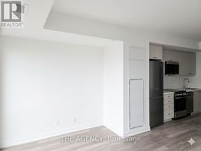 Clarington (Bowmanville) condo for rent - A white kitchen with a refrigerator, oven, and sink.