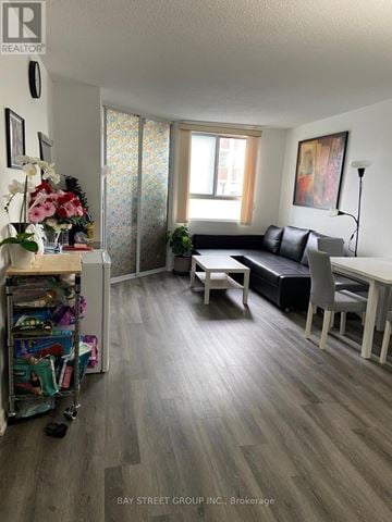 Toronto (O'connor-Parkview) condo for rent - A living room with a couch, chair, and table.