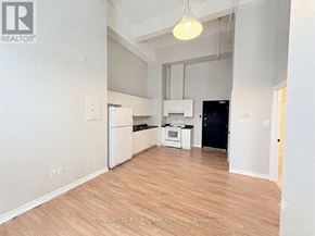 Barrie (City Centre) multi-family for rent - A kitchen with white appliances and wooden floors.