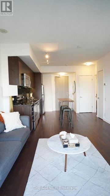 Toronto (Waterfront Communities) condo for rent - A living room with a grey couch and a white coffee table.