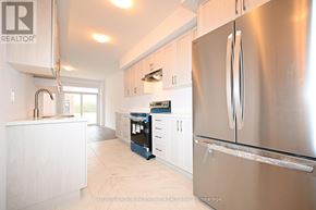 Barrie apartment for rent - A modern kitchen with a stainless steel refrigerator.