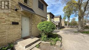 London East (East F) multi-family for rent - A house with a white door and a sign that says REALTOR.