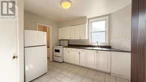 London East (East F) multi-family for rent - A kitchen with white appliances and cabinets.
