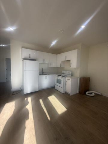 Chilliwack apartment for rent - A kitchen with white appliances and wooden floors.