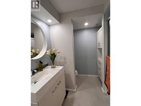 Vancouver apartment for rent - A bathroom with a sink, mirror, and towel rack.