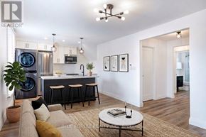 London East (East F) multi-family for rent - A modern kitchen with a bar and a living room area.