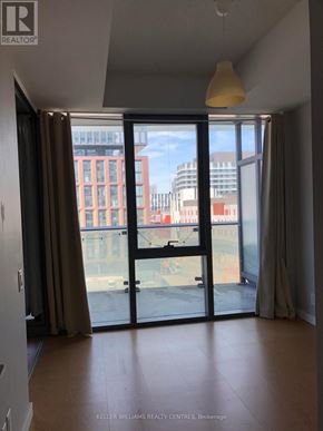 Toronto (Waterfront Communities) condo for rent - A room with a sliding glass door leading to a balcony.