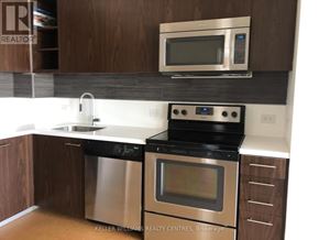 Toronto (Waterfront Communities) condo for rent - A modern kitchen with a stainless steel dishwasher and oven.