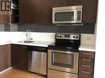 Toronto (Waterfront Communities) condo for rent - A modern kitchen with a stainless steel dishwasher and oven.