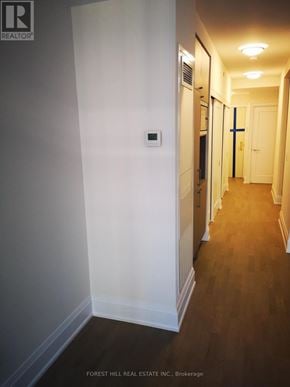 Toronto (Annex) condo for rent - A hallway with wood floors and white walls.