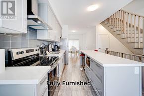 Oshawa (Samac) townhouse for rent - A fully furnished kitchen with a stove, oven, and refrigerator.
