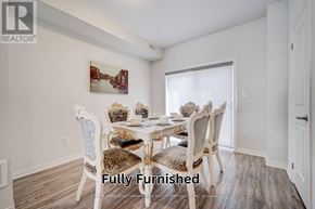 Oshawa (Samac) townhouse for rent - A dining room with a white table and chairs.
