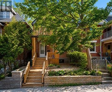 Ottawa multi-family for rent - A house with a tree in front of it.