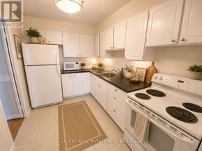 Toronto (Flemingdon Park) condo for rent - A kitchen with white appliances and cabinets.