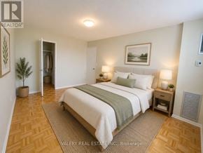 Toronto (Flemingdon Park) condo for rent - A bedroom with a large bed and a plant in a pot.