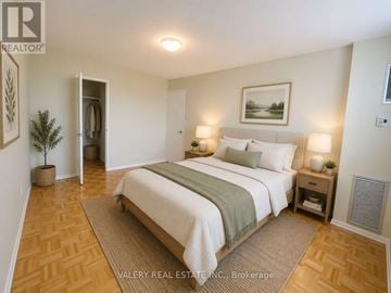 Toronto (Flemingdon Park) condo for rent - A bedroom with a large bed and a plant in a pot.
