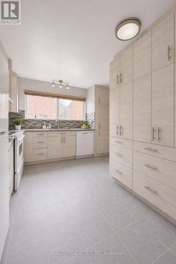 Markham (Royal Orchard) townhouse for rent - A kitchen with white cabinets and a window.